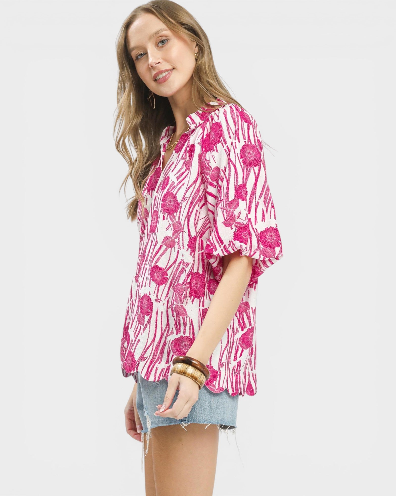 Woman wearing a pink floral blouse on a white background