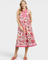 Woman wearing a sleeveless floral dress on a white background