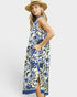 Woman wearing a floral dress with a straw hat on a white background