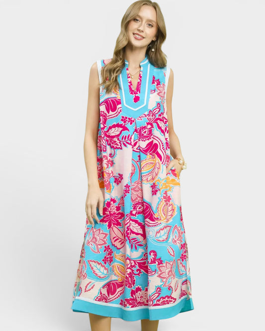 Woman wearing a colorful floral dress on a white background