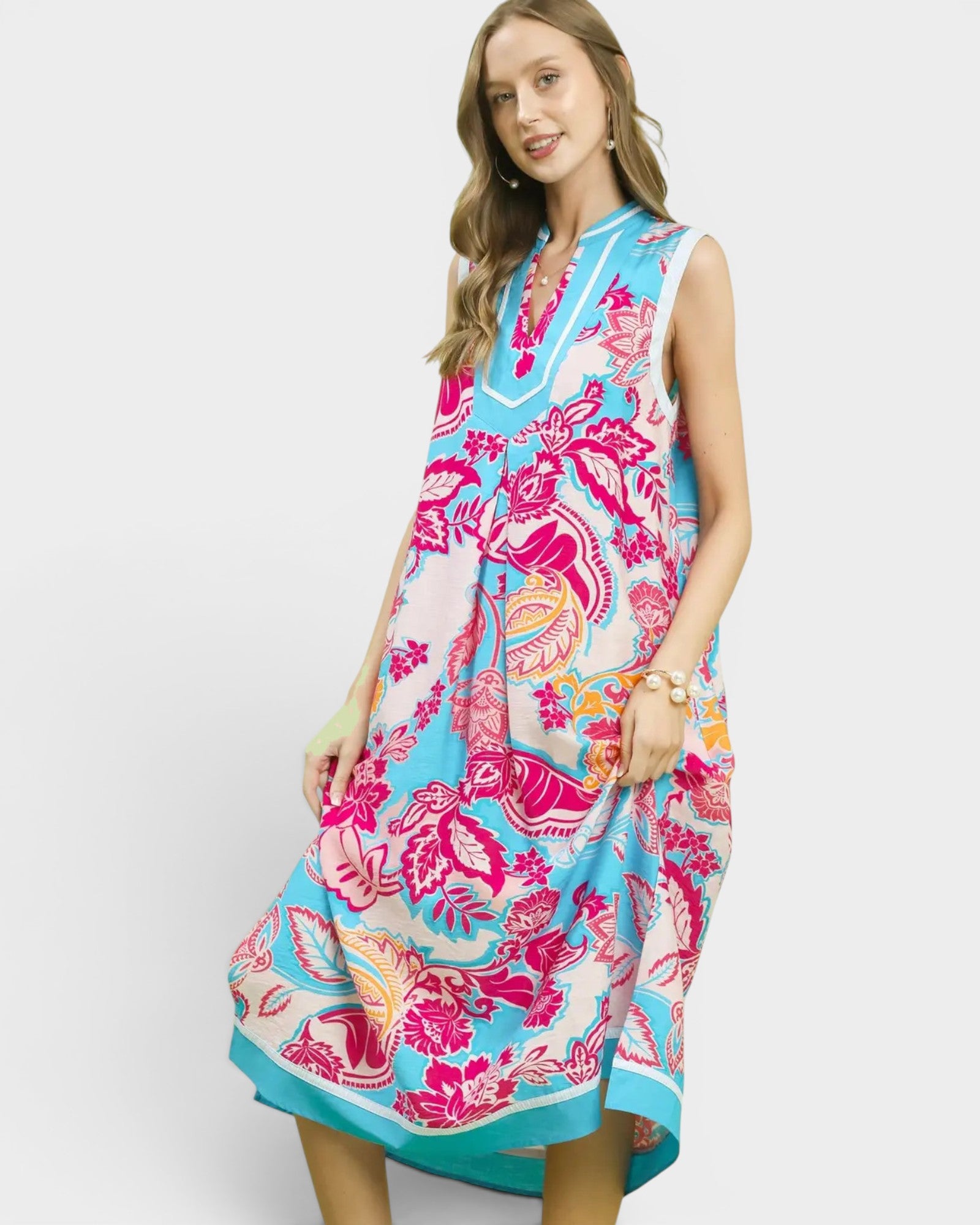 Woman wearing a colorful floral dress on a white background