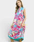 Woman wearing a colorful floral dress on a white background
