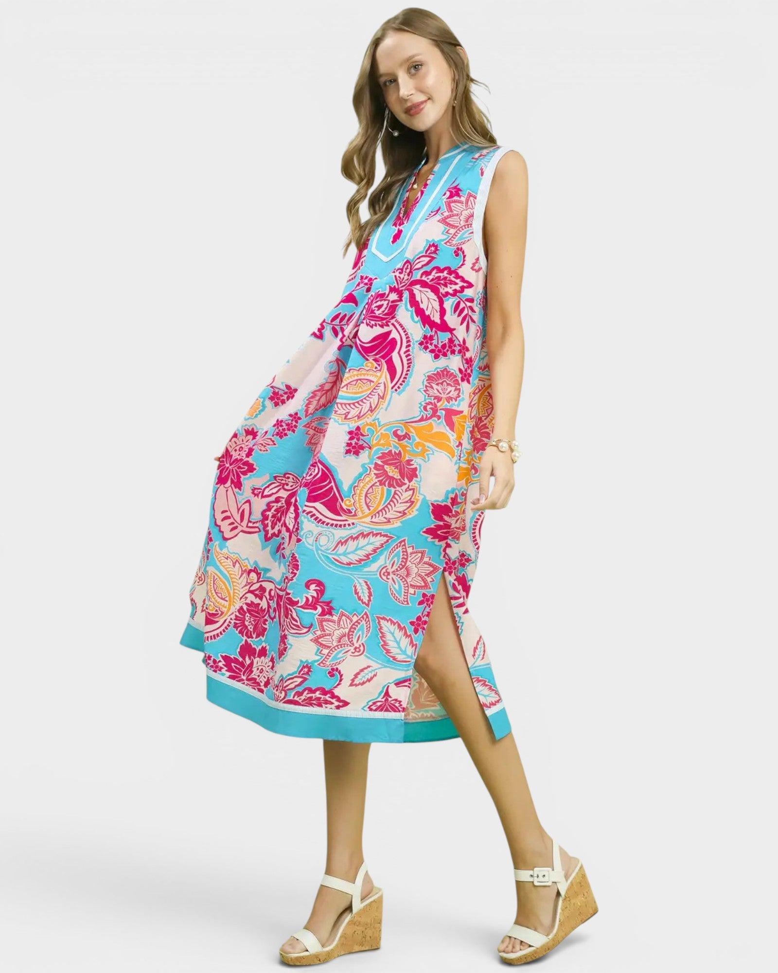 Woman wearing a colorful floral dress on a white background