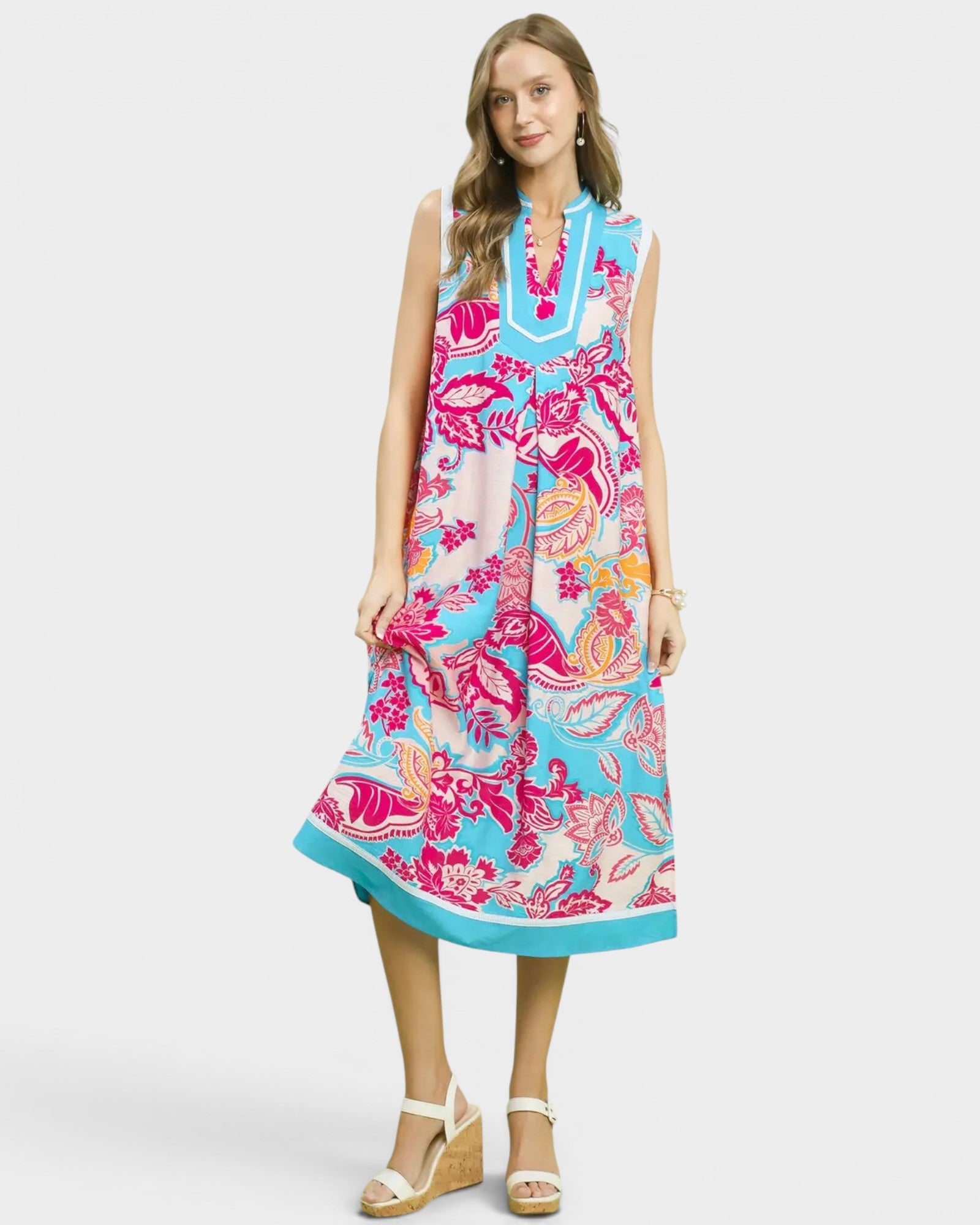 Woman wearing a colorful floral dress on a white background