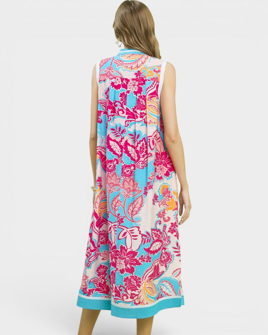 Woman wearing a colorful floral dress on a white background