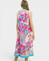 Woman wearing a colorful floral dress on a white background