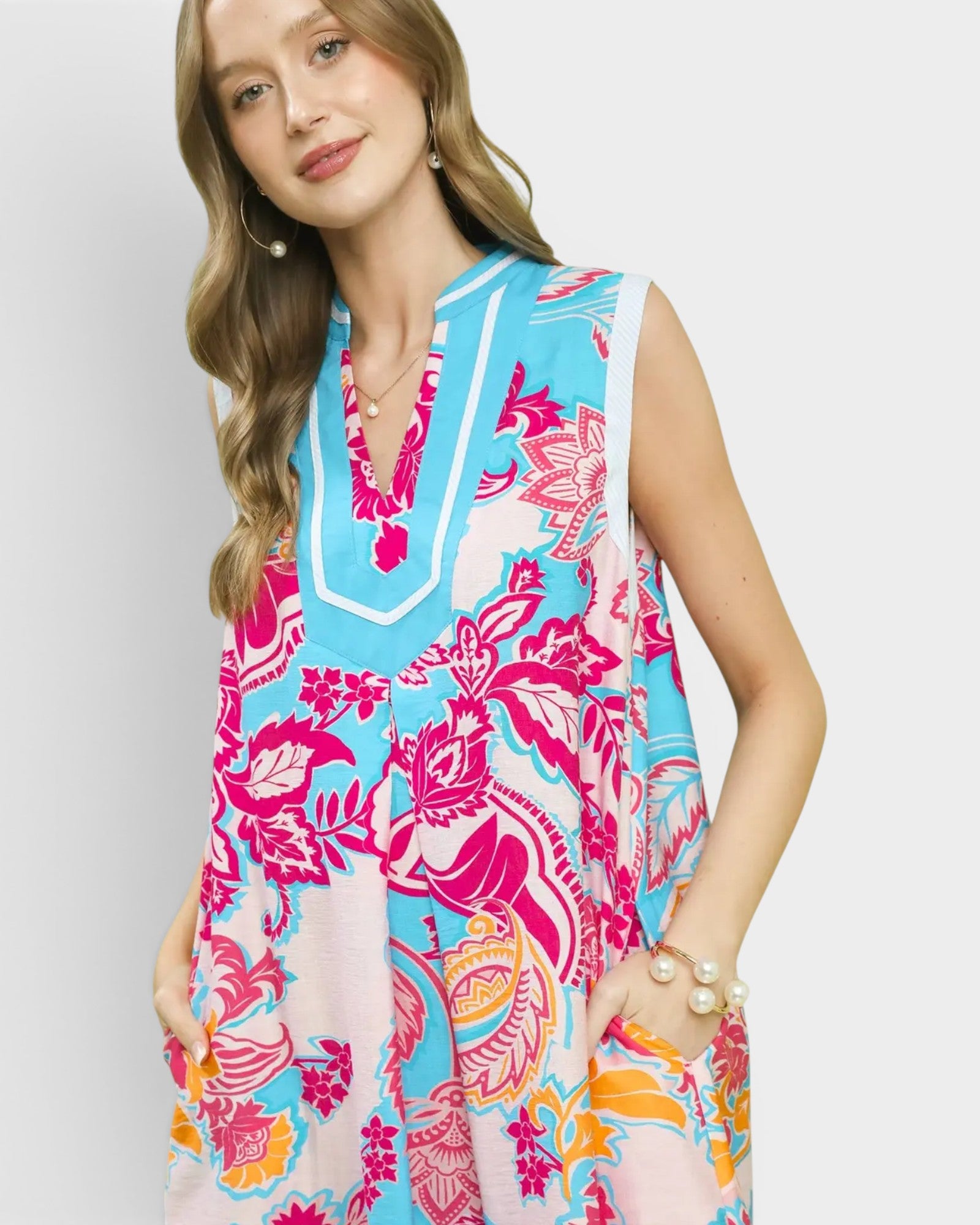Woman wearing a colorful floral dress with a white background