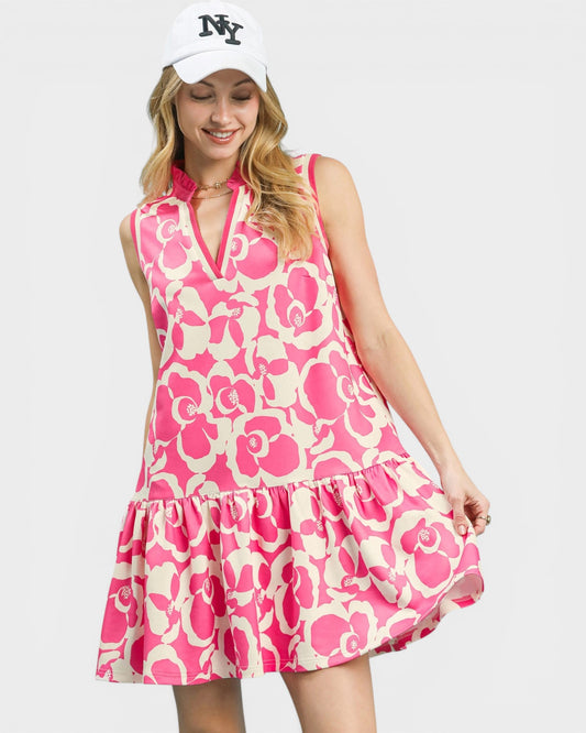 Woman wearing a pink floral dress and white cap with 'NY' on a light gray background