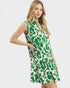 Woman wearing a green and white floral dress on a white background