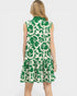 Woman wearing a green and white patterned dress on a white background
