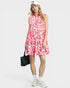 Woman wearing a pink floral dress on a white background
