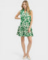 Woman wearing a green and white patterned dress on a white background