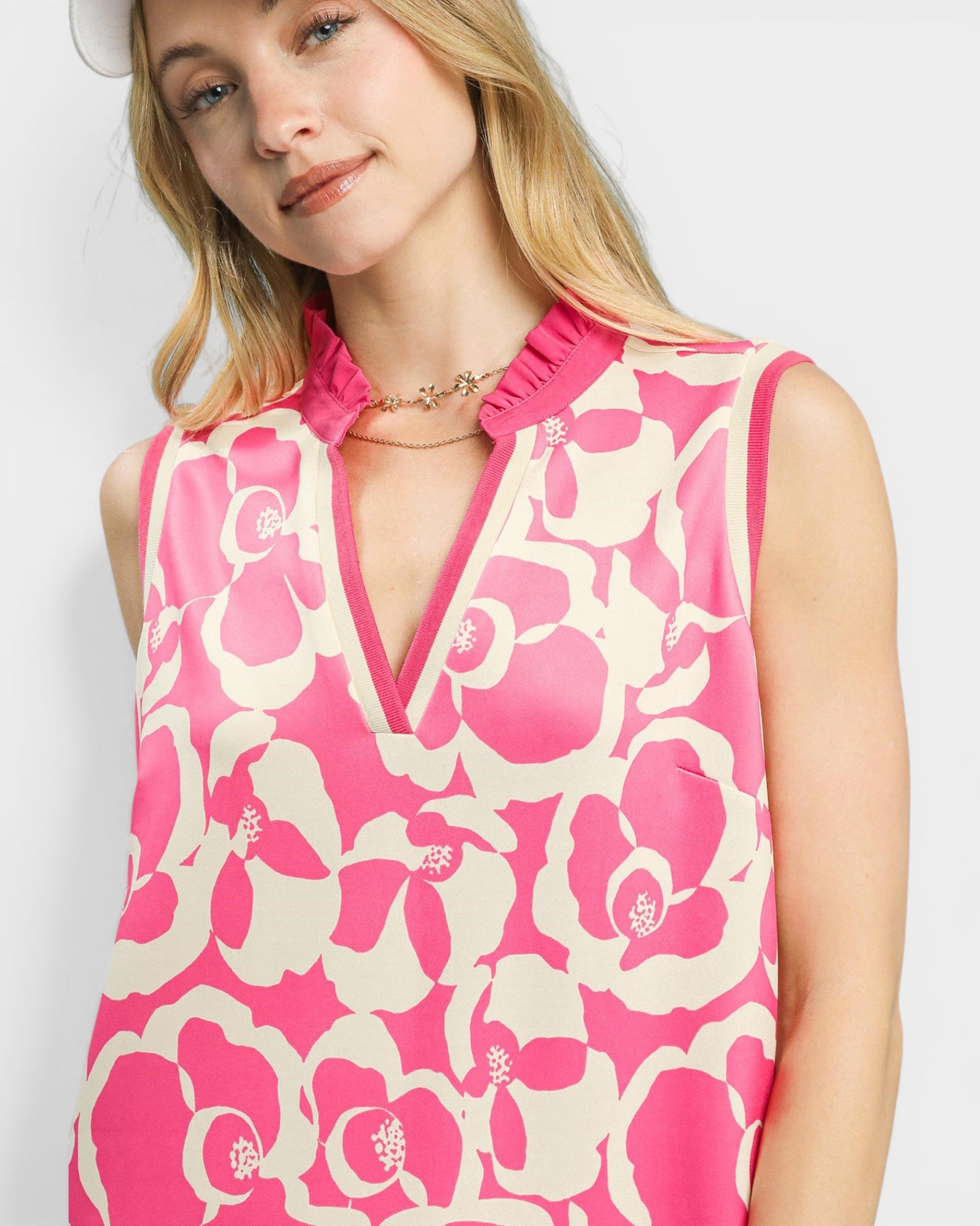 Woman wearing a pink floral dress on a white background