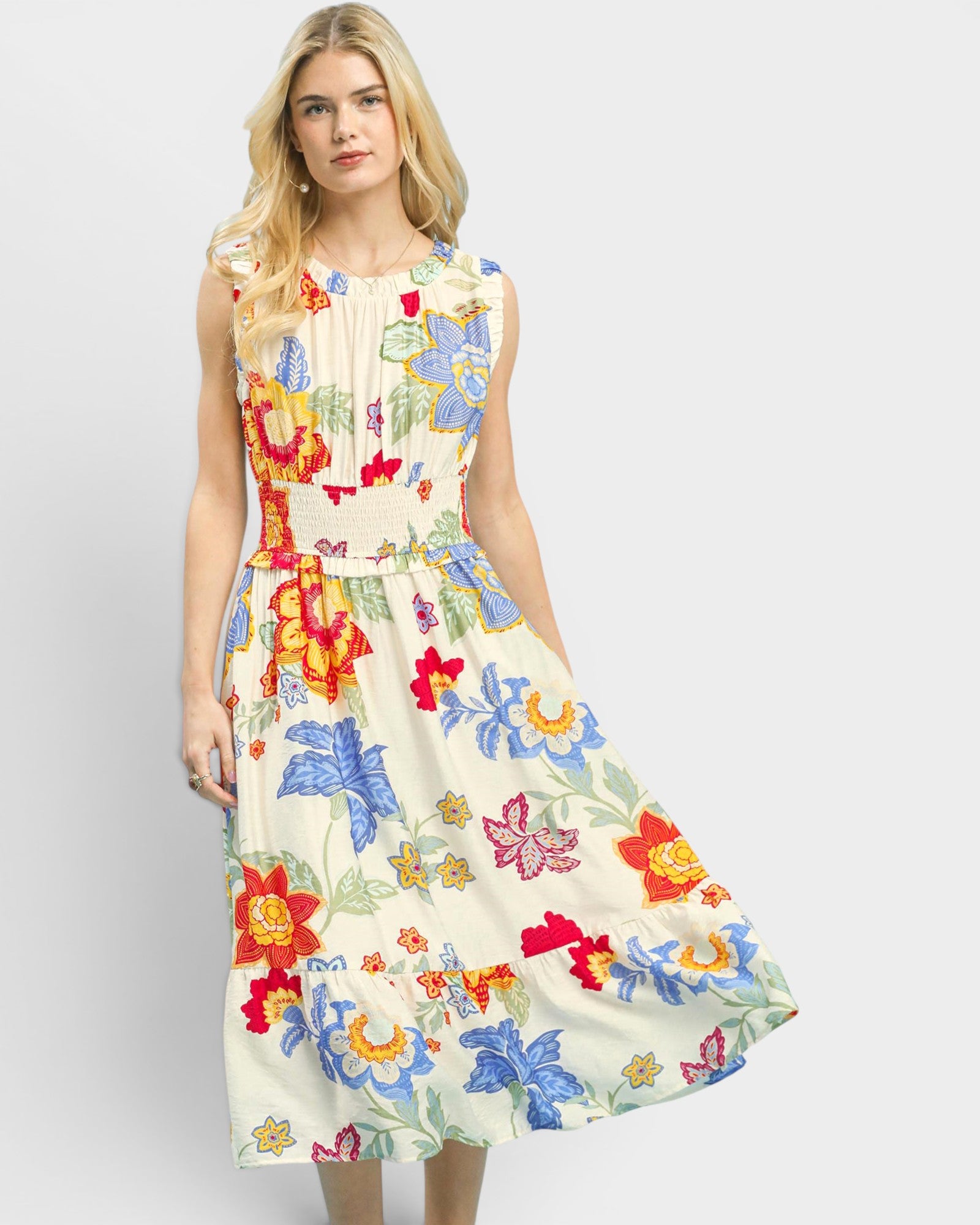 Woman wearing a colorful floral dress on a white background