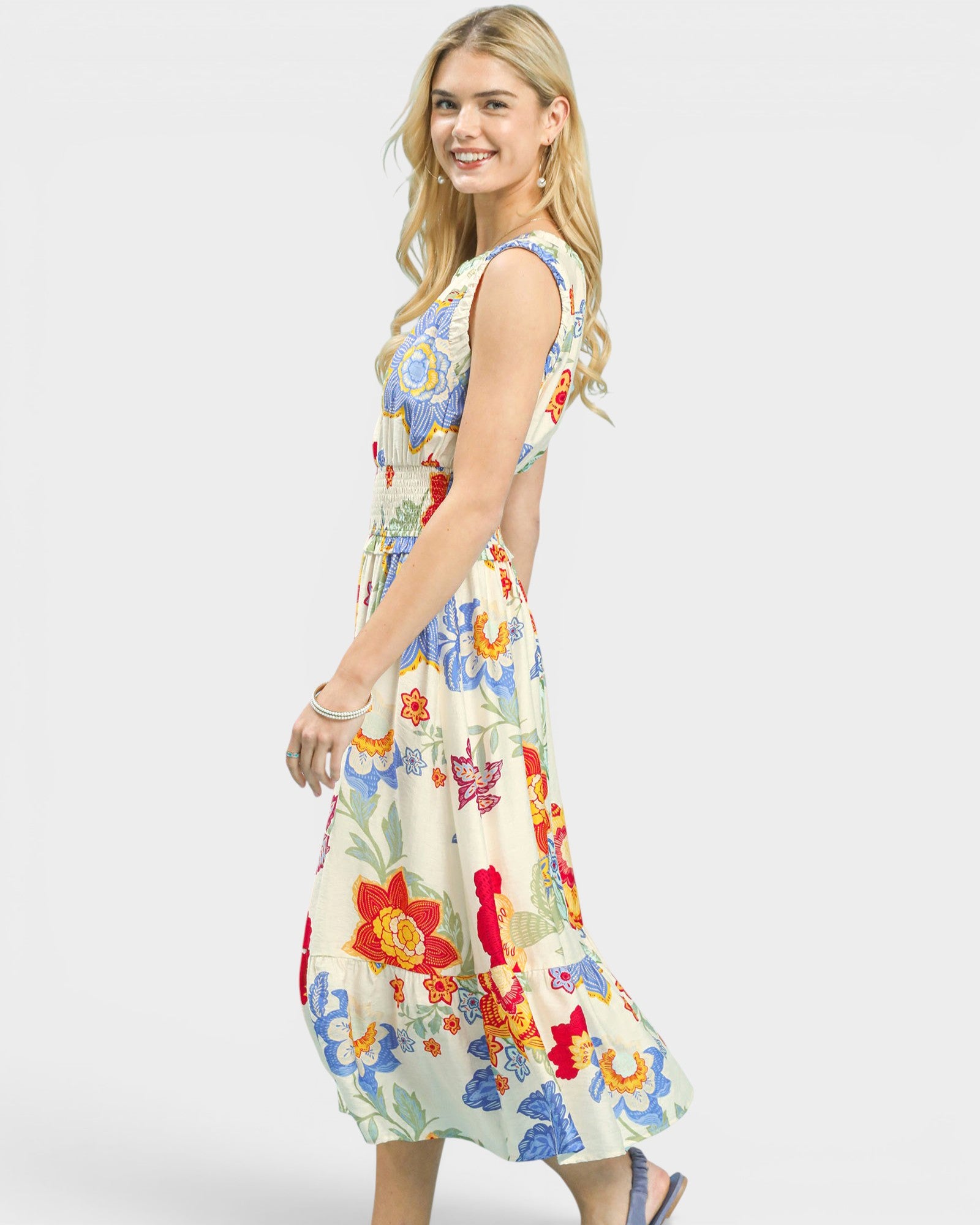 Woman wearing a colorful floral dress on a white background