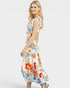 Woman wearing a colorful floral dress on a white background