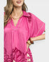 Woman wearing a pink floral dress with a white background