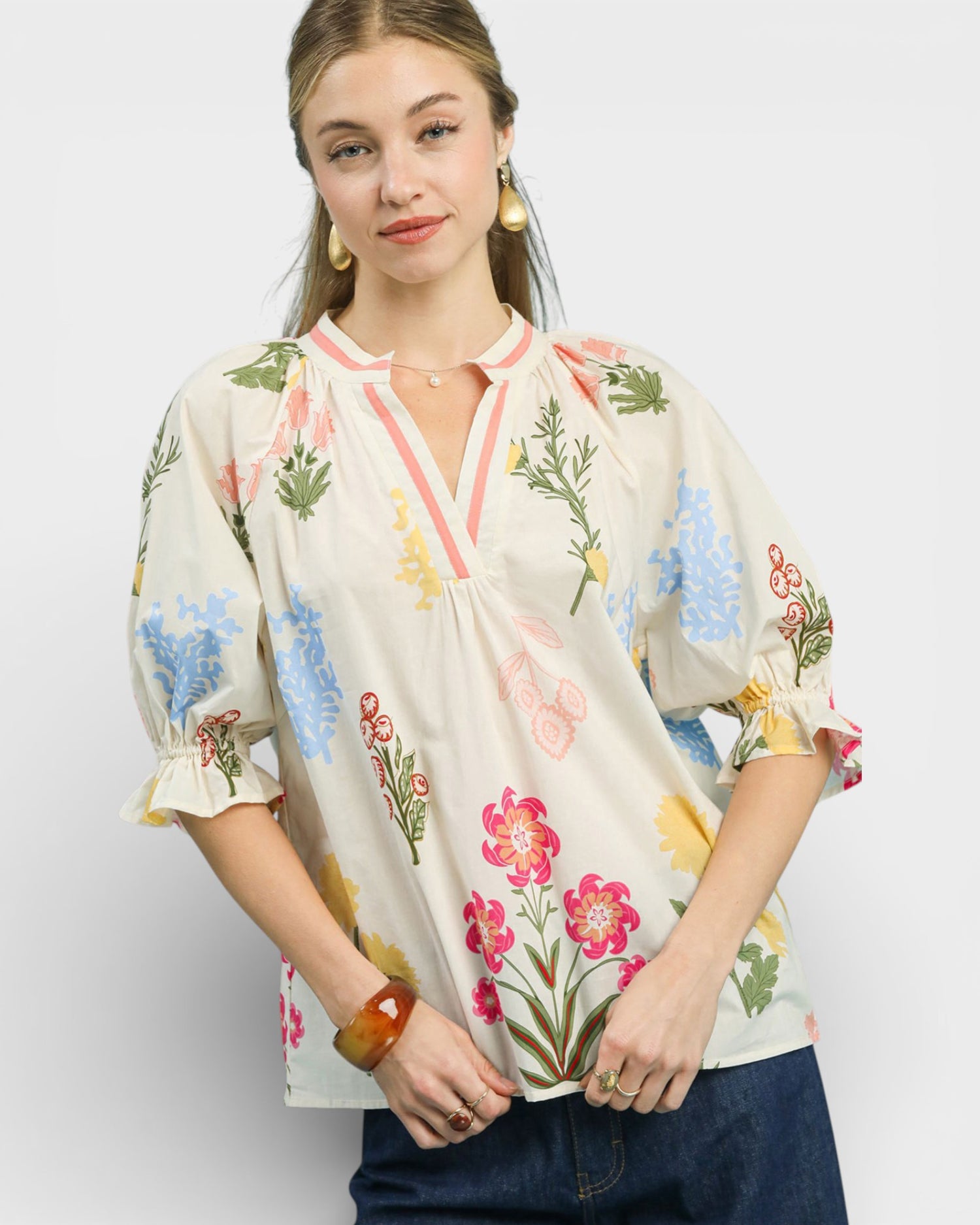 Woman wearing a floral blouse with a plain background