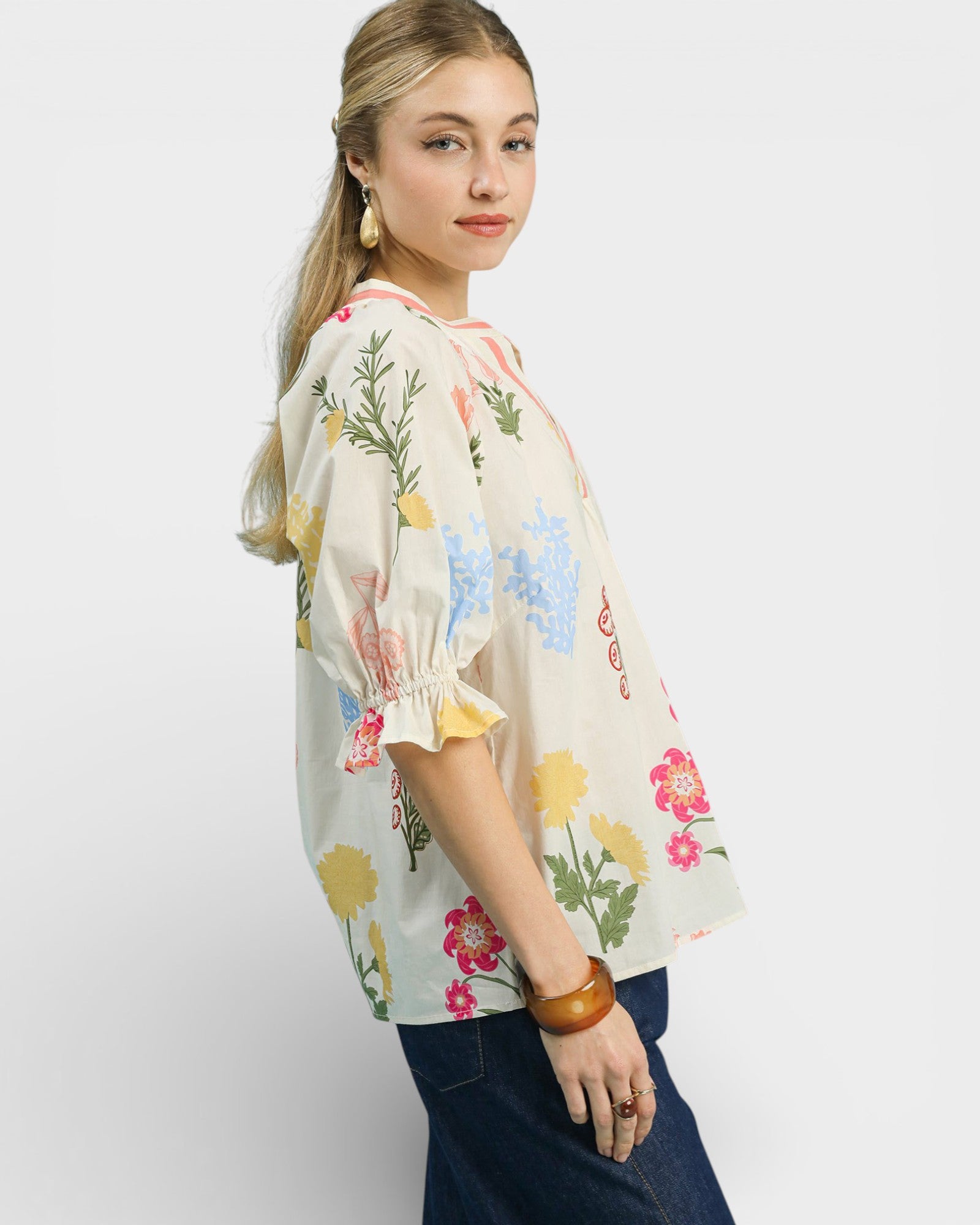 Woman wearing a floral blouse with a plain background