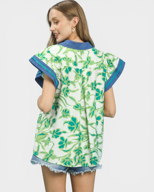 Girl wearing a green floral kimono-style garment on a white background