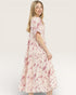 Woman wearing a floral dress on a white background