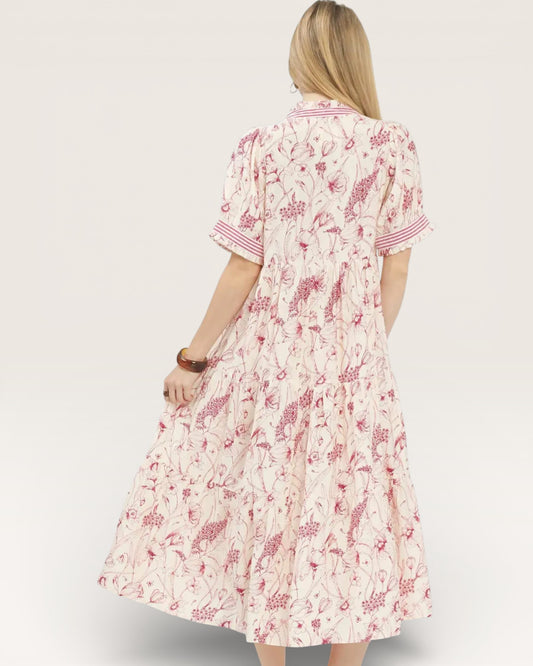 Woman wearing a floral dress on a plain background