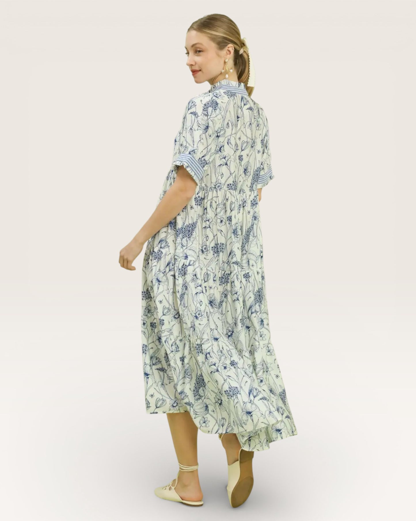 Woman wearing a floral dress on a white background