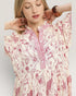 Woman wearing a floral dress with a white background