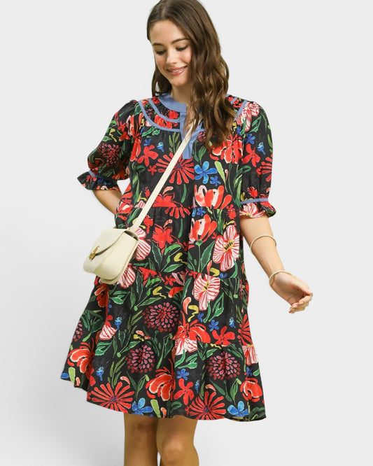 Woman wearing a colorful floral dress with a white background