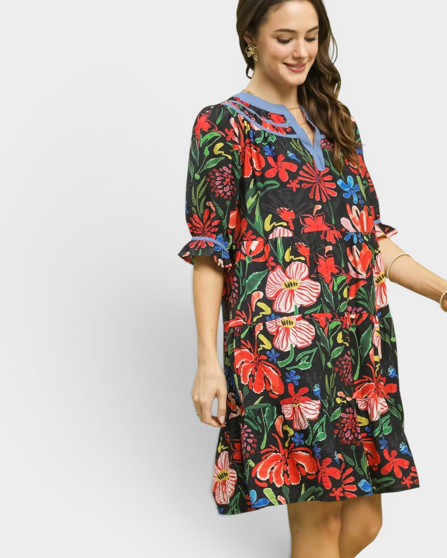 Woman wearing a colorful floral dress on a white background