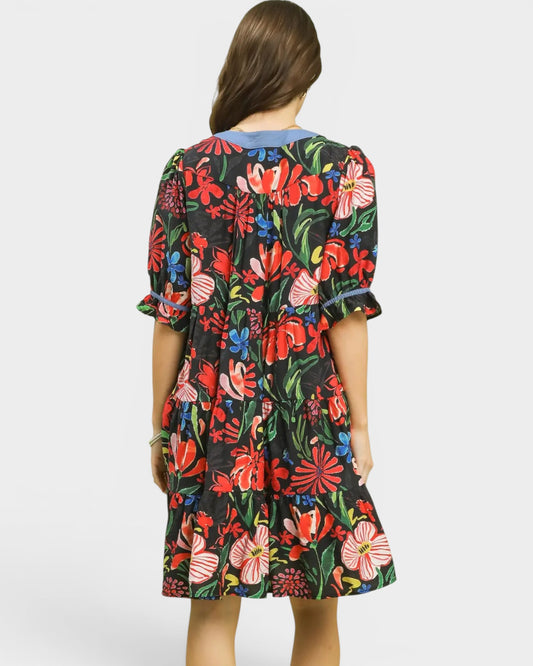 Woman wearing a colorful floral dress on a white background