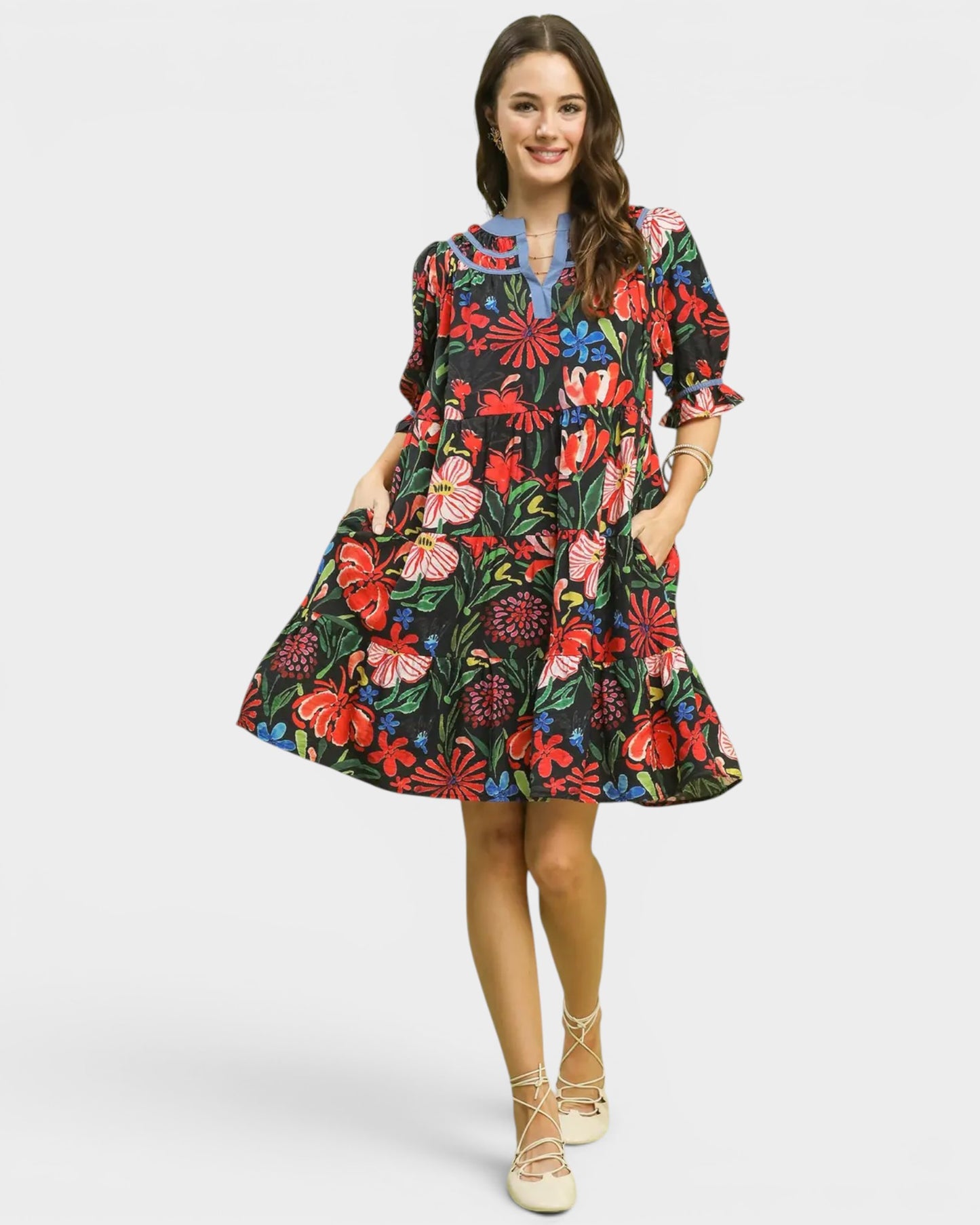 Woman wearing a colorful floral dress on a white background