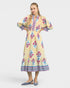 Woman wearing a yellow dress with floral patterns on a white background