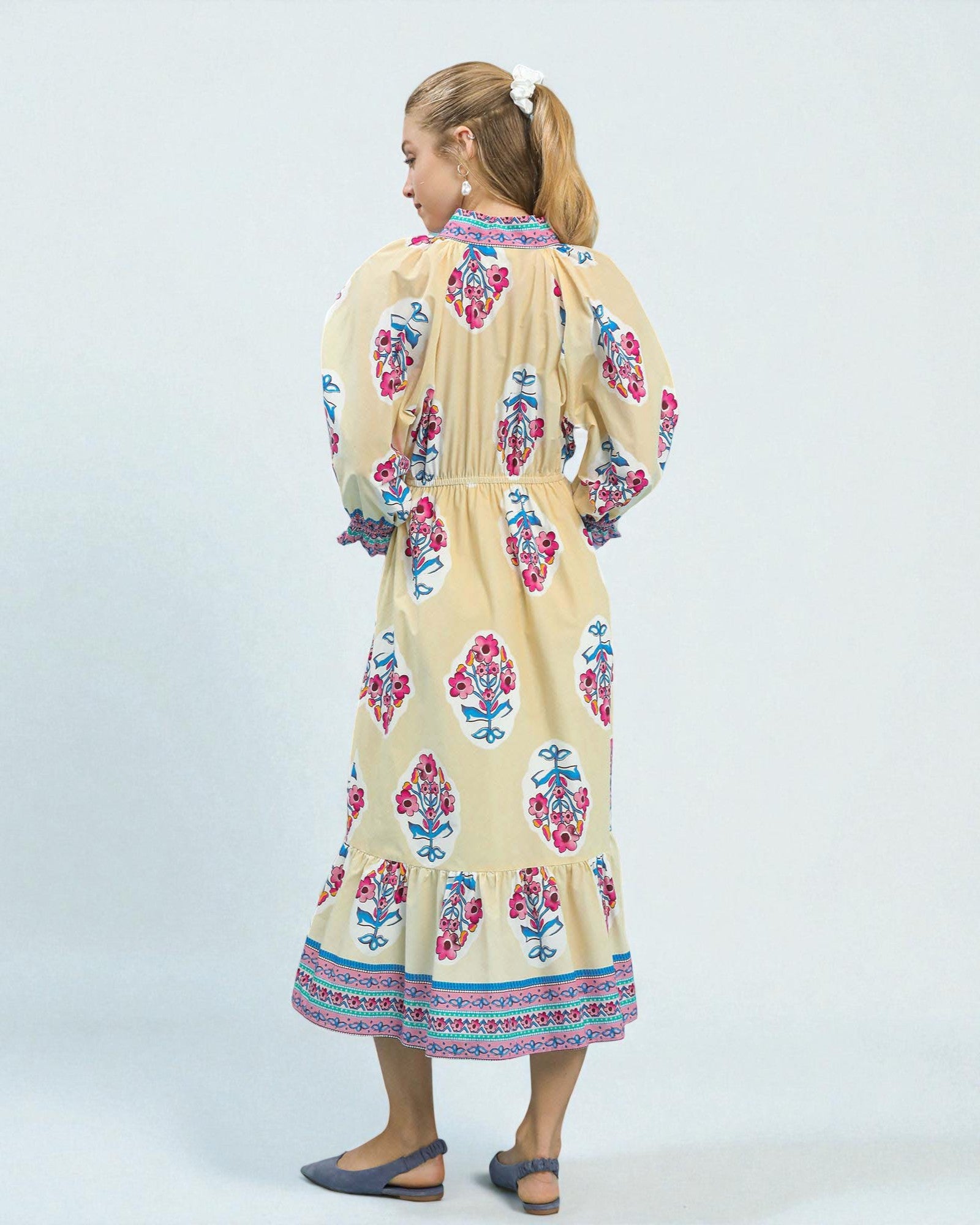 Woman wearing a floral dress on a white background