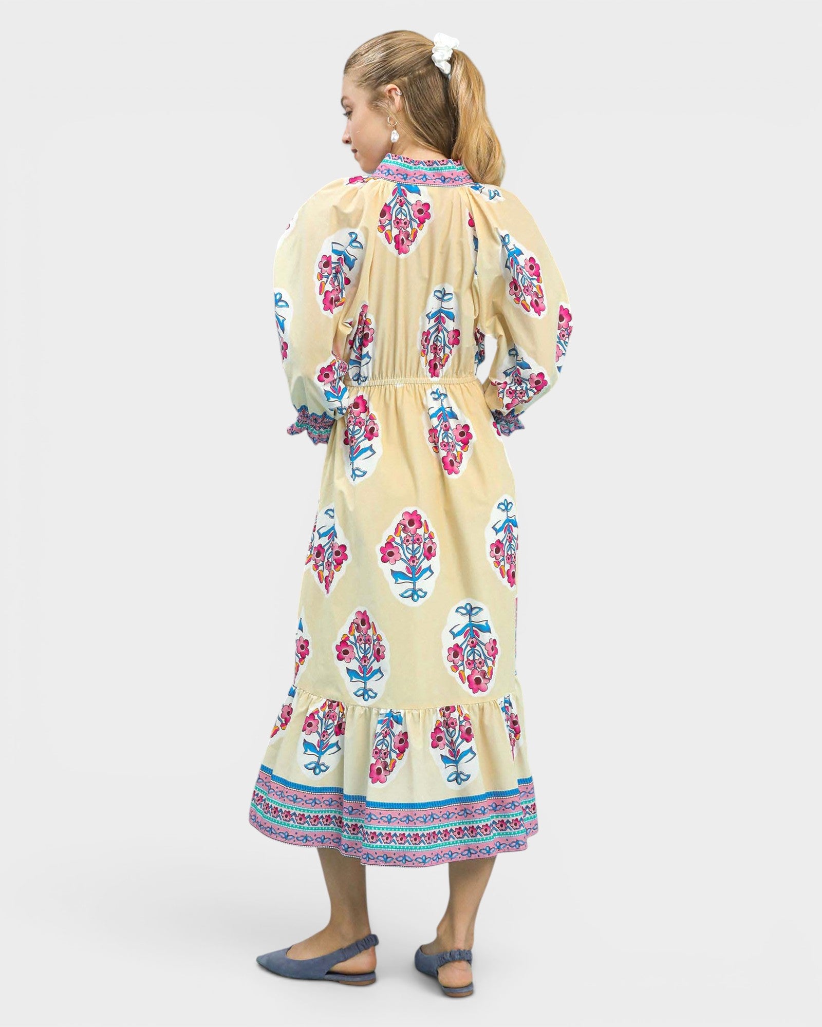 Woman wearing a floral dress with a white background
