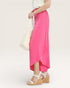 Person wearing a bright pink skirt with a white background