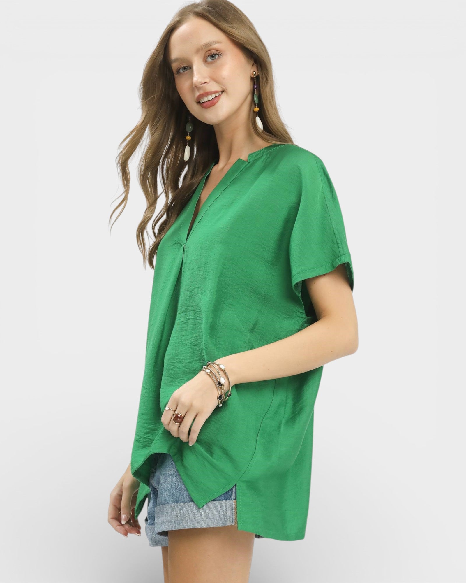 Woman wearing a green top on a white background