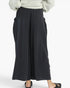 Black wide-leg cropped pants with side tie details, shown on a model wearing a light gray top and black sandals against a plain white background.