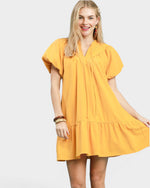 Woman wearing a yellow dress on a white background