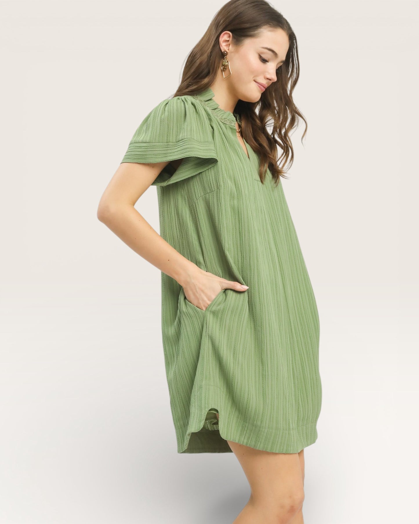 Woman wearing a green dress on a white background