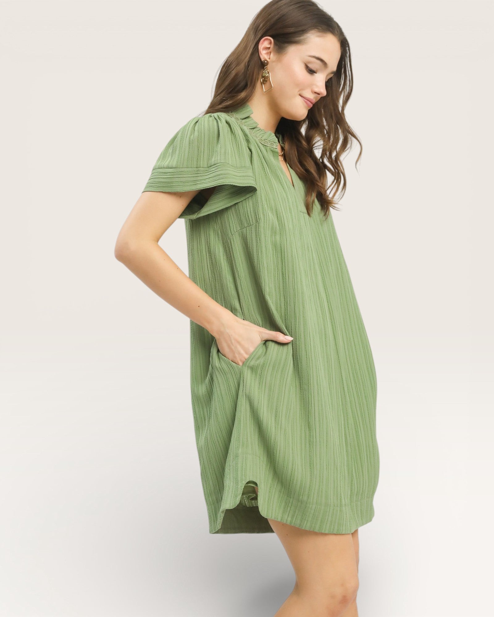 Woman wearing a green dress on a white background