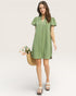 Woman wearing a green dress holding a woven basket with flowers on a white background