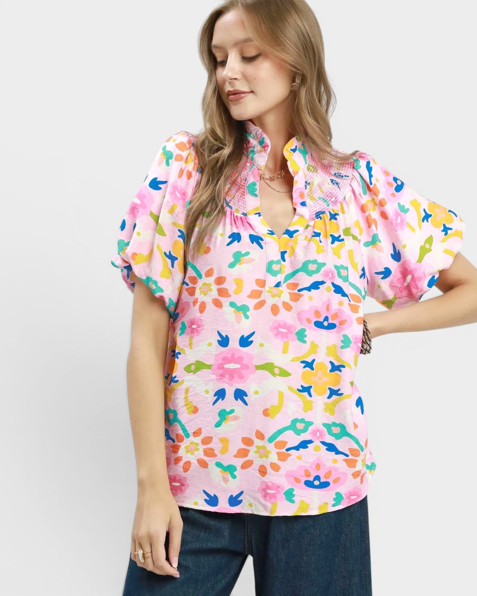Woman wearing a colorful floral blouse on a white background