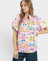 Woman wearing a colorful floral blouse on a white background