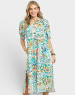 Woman wearing a colorful floral dress on a white background