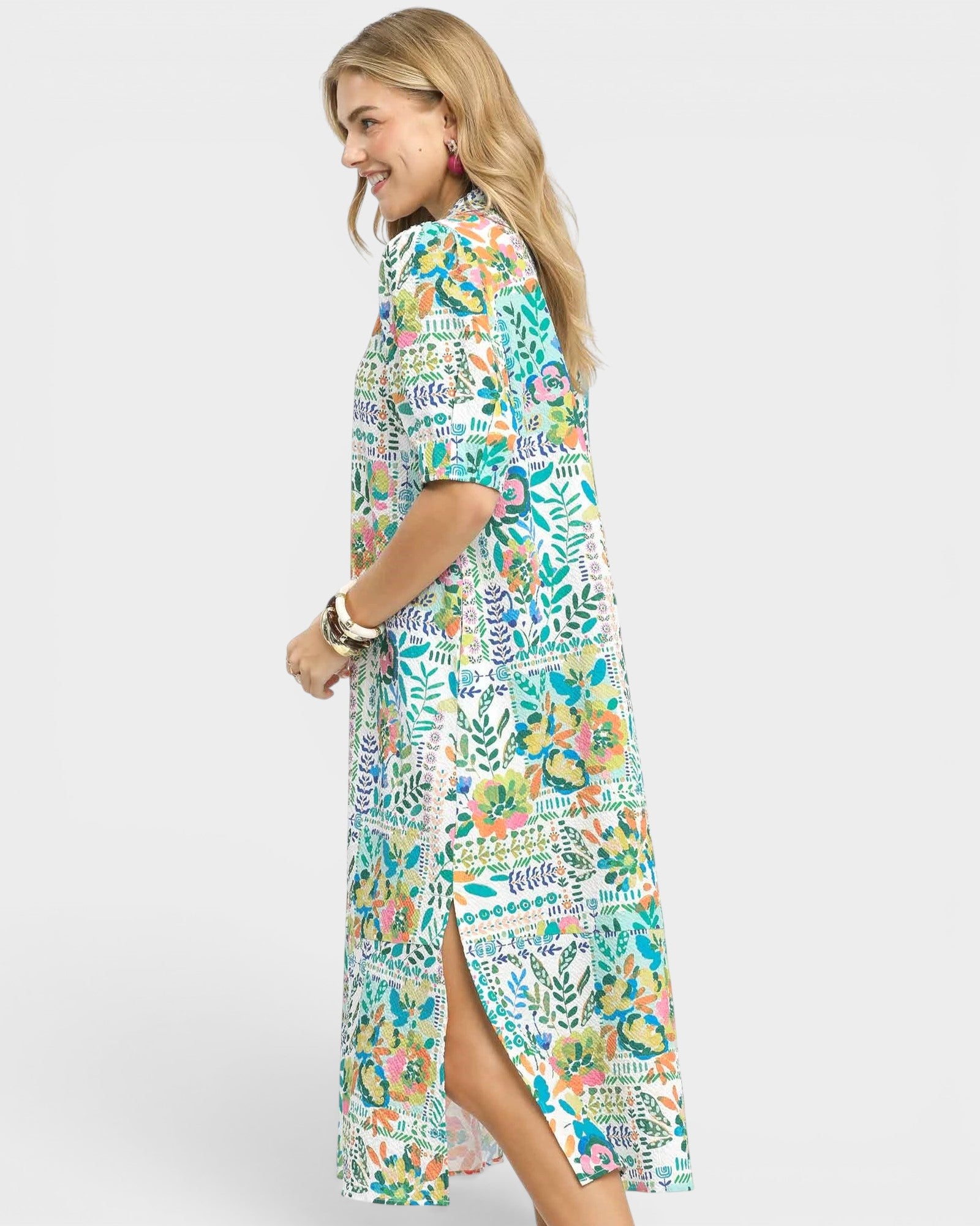 Woman wearing a colorful floral dress on a white background