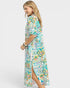 Woman wearing a colorful floral dress on a white background