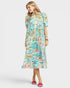 Woman wearing a colorful floral dress on a white background