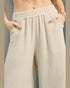 Beige wide-leg pants worn by a person with a neutral background