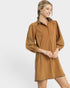 Woman wearing a brown dress with long sleeves on a white background